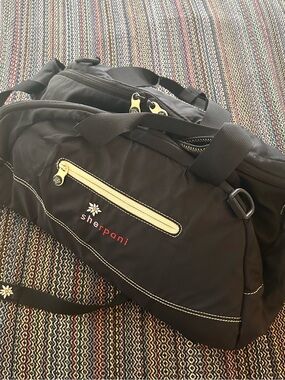 Sherpani Black Duffel Bag with Cream Accents